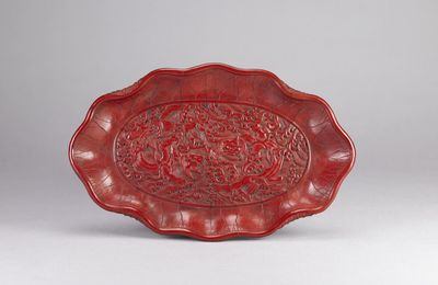 Red Lacquer Lotus Leaf-shaped Dish with Carved Double Chi-dragon Design, Ming dynasty, Xuande Period (1426-1435)