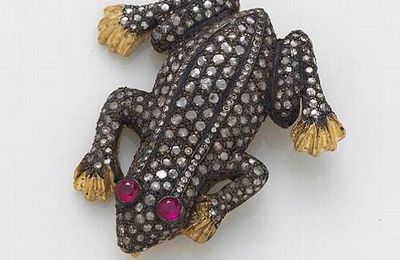 A diamond, ruby, silver-topped 10k gold and metal brooch in a frog motif