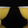  A fine pair of yellow-glazed engraved dragon bowls, China, Qianlong six-character sealmarks and of the period