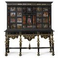 An Italian Baroque reverse-painted verre églomisé and tortoiseshell-inlaid parcel-gilt ebonized cabinet on stand