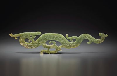 A large yellowish-green jade dragon-form pendant, Warring States period, 4th-3rd century BC
