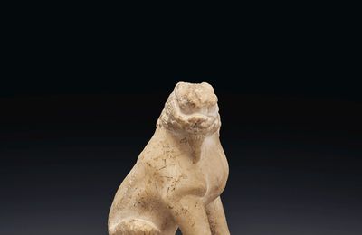 A small white marble figure of a seated lion, Tang dynasty (AD 618-907)