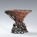 A carved rhinoceros horn 'Lotus Pond' libation cup, Qing Dynasty, 17th-18th century