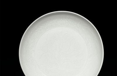 A fine early Ming anhua-decorated tianbai 'lotus bouquet' dish, Yongle period (1403-1425)