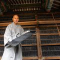 A South Korean monk shows a wooden printing block from the Tripitaka Koreana or Palman Daejanggyeong 