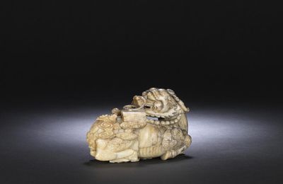 A superb large grey and pale yellow jade carving of a qilin, 17th century