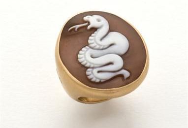 A gold ring by Pomellato with snake on came