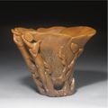 A Carved Rhinoceros Horn 'Blossom and Qilong' Libation Cup. 17th Century