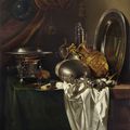 Willem Kalf, A chafing dish, two pilgrims' canteens, a silver-gilt ewer, a plate and other tableware on a partially draped table