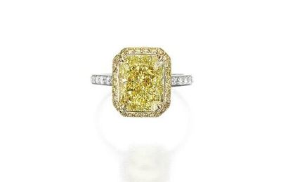 Platinum, 18 karat gold, fancy intense yellow diamond, colored diamond and diamond ring