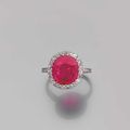 Chaumet. Bague ornée d'un rubis de forme coussin dans un entourage de petits diamants. 