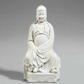 A blanc de Chine figure of a seated Guandi. Dehua. 17th century