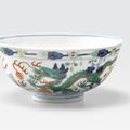 A wucai-decorated dragon and phoenix bowl, Guangxu six-character mark and of the period (1875-1911)
