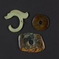 Three items of nephrite, comprising two bi-discs and a pendant carved as a mythological animal