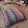 Coussin multicolore en tricot avec des franges 