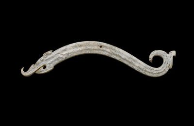 A calcified jade 'dragon' pendant, huang, Eastern Zhou dynasty, Warring States period (475-221 BC)