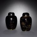 A pair of mirror black vases and covers