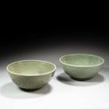 Two large Longquan celadon-glazed 'lotus and waves' bowls, Yuan-Ming dynasty, 14th-15th century