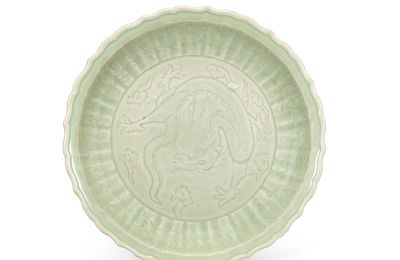 A rare carved Longquan celadon 'dragon' dish, Yuan dynasty (1279-1368)