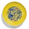 A rare yellow-ground wucai ‘Dragon’ dish, Kangxi mark and period