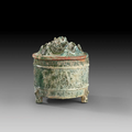 A green glazed pottery tripod jar and cover, 'Lian', Han dynasty (206 BC-220 AD)