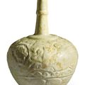 A white glazed moulded pottery bottle, Kashan, Seljuk Iran, 12th century