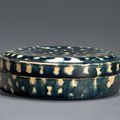 A blue-glazed applique-decorated box and cover, Tang dynasty, 618-907