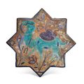 A Kashan lustre, turquoise and cobalt-blue star tile, Iran, late 13th-early 14th century