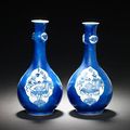 A pair of blue and white powder-blue-ground pear-shaped vases. Kangxi