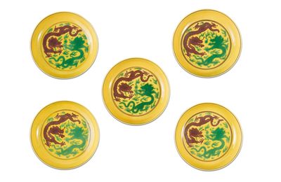 Five yellow-ground green and aubergine-enamel 'dragon' dishes, Qianlong seal marks and period