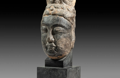 A limestone head of a Bodhisattva China, Longmen, Tang dynasty (618-907).
