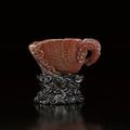 A RARE AND EXQUISTELY CARVED SMALL RHINOCEROS HORN PHOENIX-FORM LIBATION CUP - MING DYNASTY, 17TH CENTURY