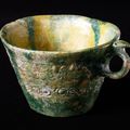 Earthenware cup with molded or stamped decoration and a yellow and green glaze, Iraq or Syria, 8th-9th century