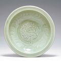 A molded and carved Longquan celadon dish, Yuan dynasty, late 13th-early 14th century