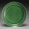 A green-glazed 'dragon' saucer. Qianlong seal mark and period