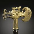 A gilt-bronze dragon head axe fitting. Tang dynasty