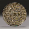 A cast bronze 'Lion and Grape' mirror. Tang dynasty.
