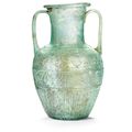 A Roman two-handled blue-green glass amphora signed by Ennion, circa first half of the 1st century A.D.