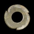 A celadon jade notched disc, Late Neolithic period-Shang dynasty