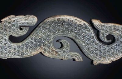 A large greyish-green jade dragon-form pendant, Warring States period, 4th century BC