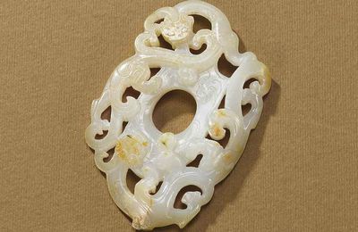 A white and russet jade 'dragon' pendant, Han dynasty (206 BC-220 AD)