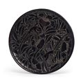 A carved black lacquer circular dish, China, Yuan-early Ming dynasty, 14th century