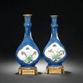 A pair of ormolu-mounted powder-blue-ground and famille verte pear-shaped bottle vases. The porcelain Kangxi