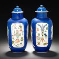 A pair of famille verte powder-blue-ground cylindrical jars and two covers. Kangxi