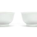 A rare pair of white-glazed anhua 'dragon' bowls, Chenghua six-character marks, 17th-18th century
