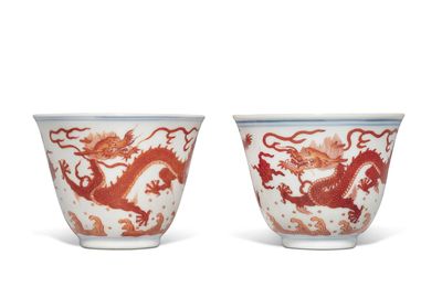 A pair of iron-red 'dragon' cups, Seal marks and period of Qianlong
