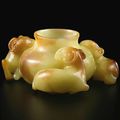 A superbly carved yellow and russet jade 'three rams' waterpot, Qing dynasty, 18th century