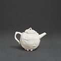 A small and inscribed blanc-de-Chine ewer and cover, 17th century