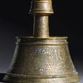 An important Mamluk silver-inlaid brass candlestick, Egypt, late 13th-first half 14th century