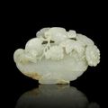 A rare pale green jade carving of a Mandarin duck and peony blossoms, Qianlong